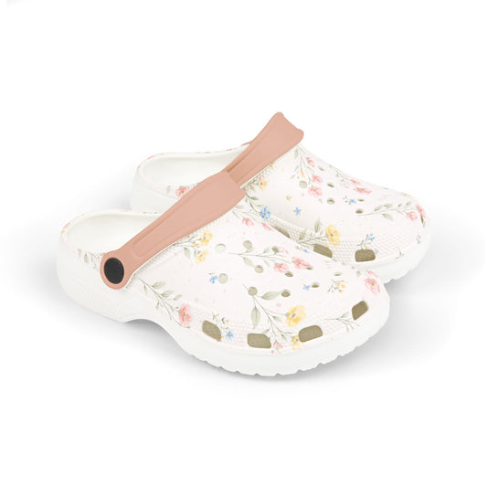 Floral-patterned clogs with a pink strap on a white background