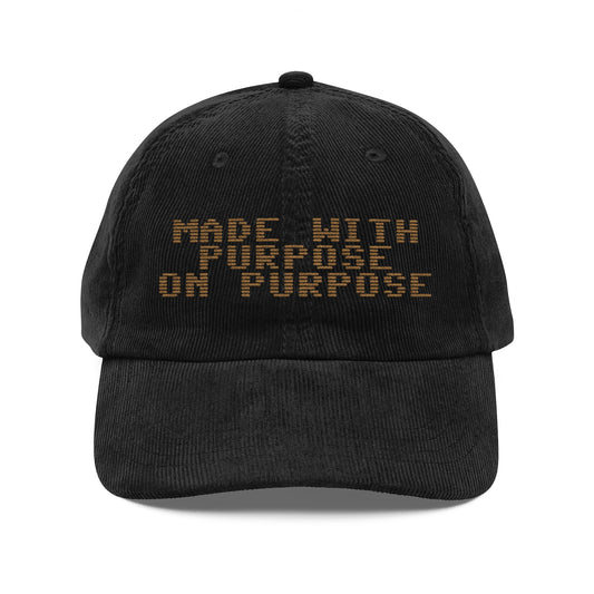 Black cap with 'MADE WITH PURPOSE ON PURPOSE' text on a white background