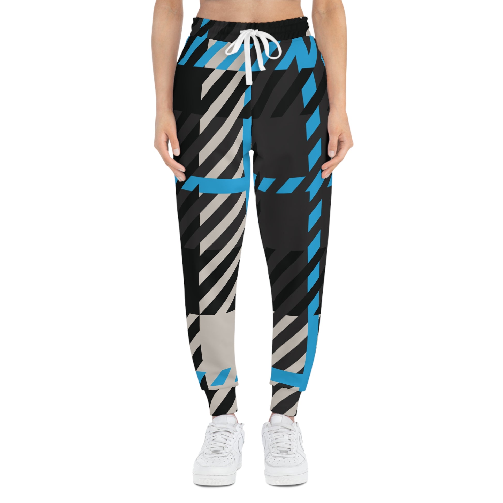 Person wearing black, blue, and gray striped pants on a white background