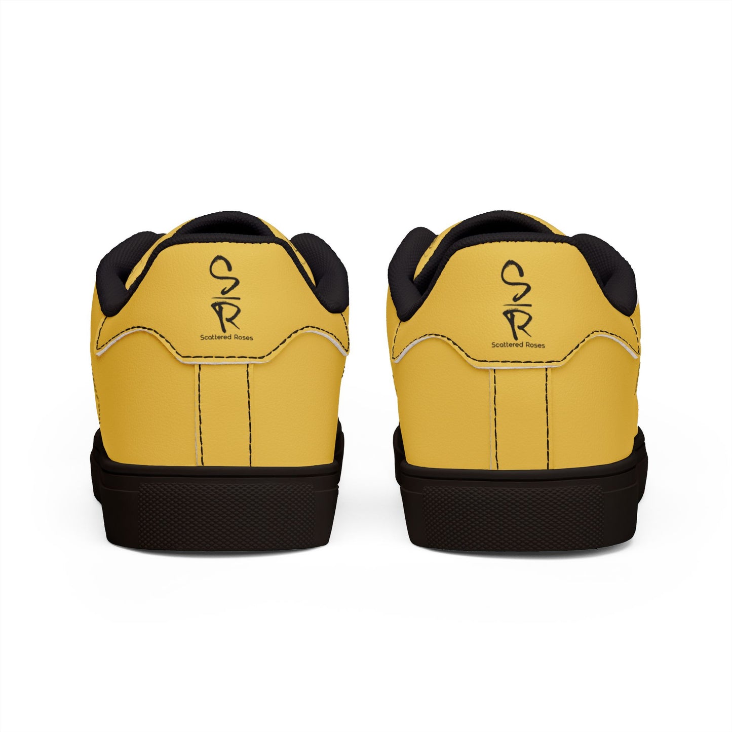 Yellow sneakers with black soles and a logo on a white background