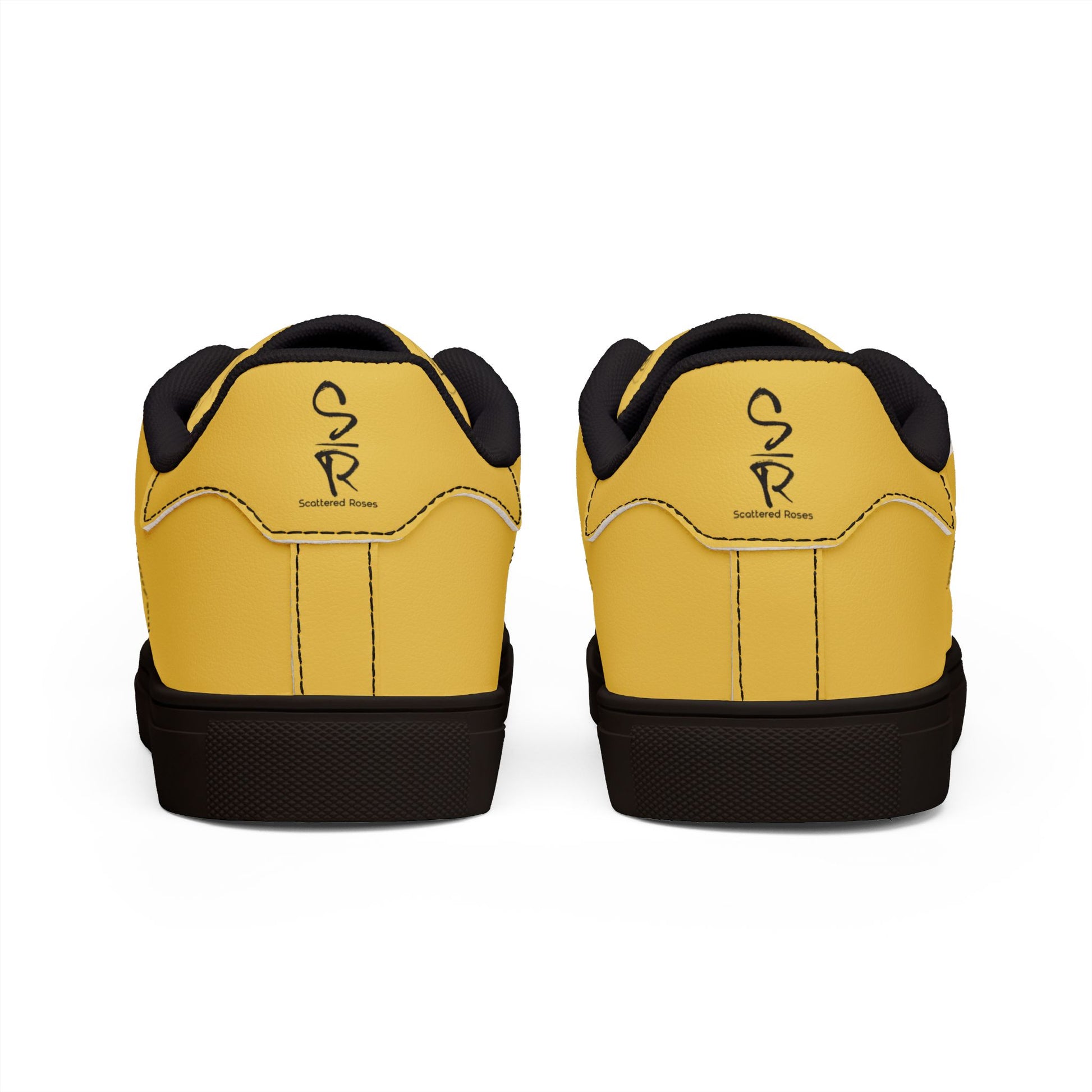 Yellow sneakers with black soles and a logo on a white background