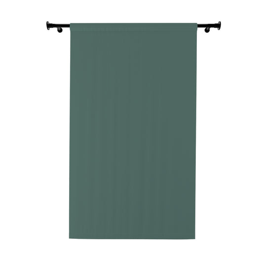 Green curtain hanging on a rod against a white background
