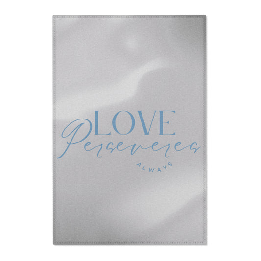 Silver foil card with 'Love Perseveres Always' text