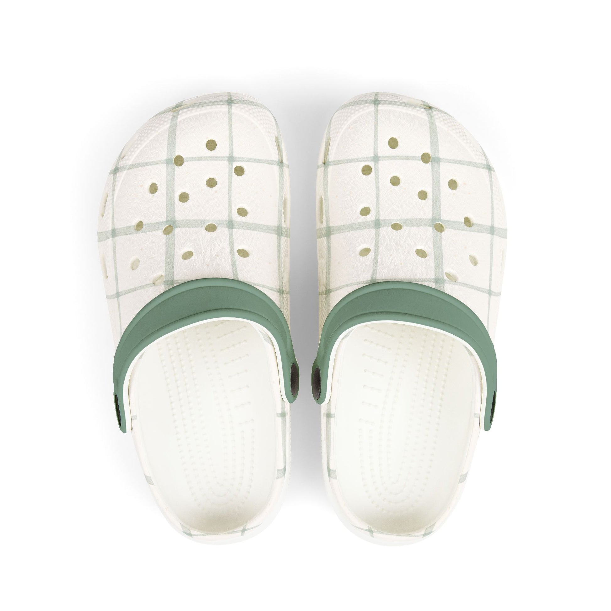 Pair of white slippers with green straps on a white background