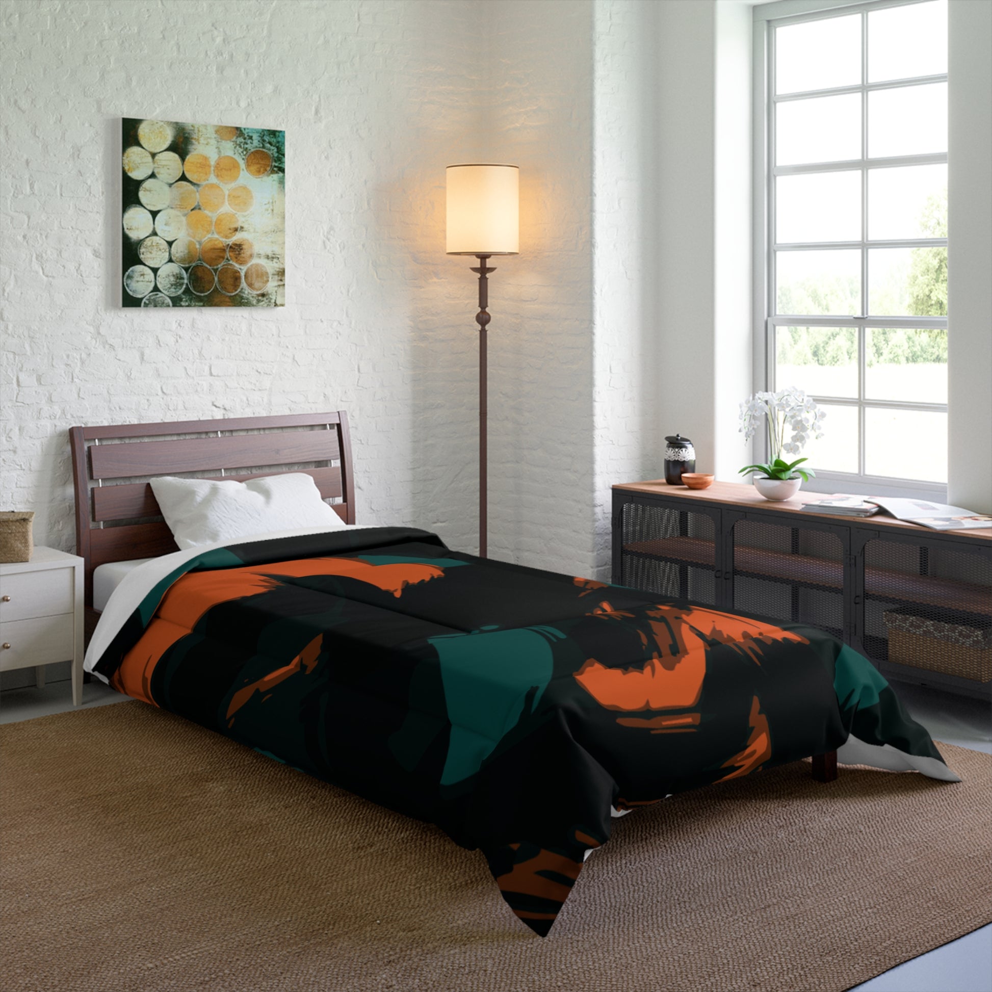 Bedroom with a bed featuring a black and orange comforter, a lamp, and a window.