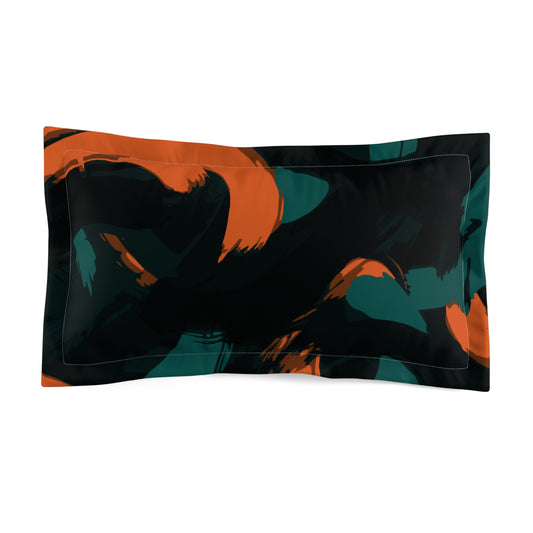 Decorative pillow with abstract design in orange, black, and teal on a white background