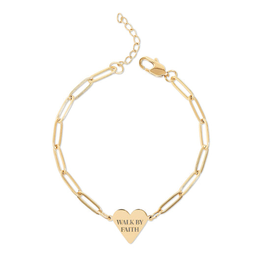 Gold bracelet with a heart-shaped tag that says 'Walk by Faith' on a white background
